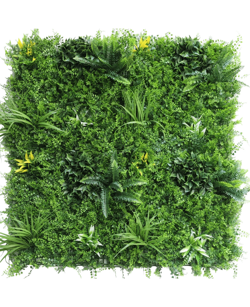 La Haie Artificielle Moment 100x100 cm UV est un panneau carré densément recouvert de plantes vertes artificielles, de fougères, de pétioles et de petites fleurs jaunes éparses sur fond blanc.
